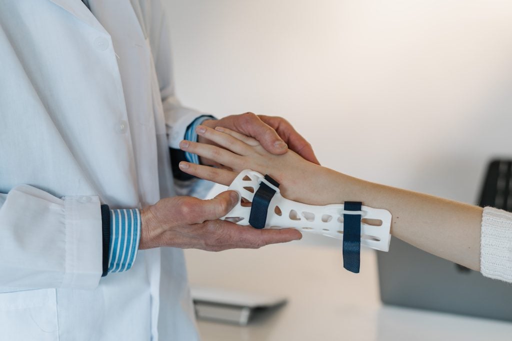 Doctor examining an injured wrist