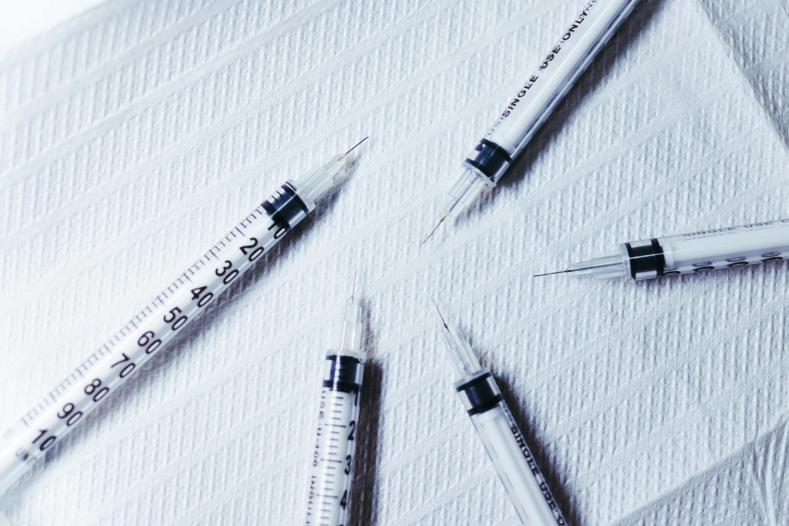 Close-up of syringes on a paper towel for a Lupron lawsuit case review