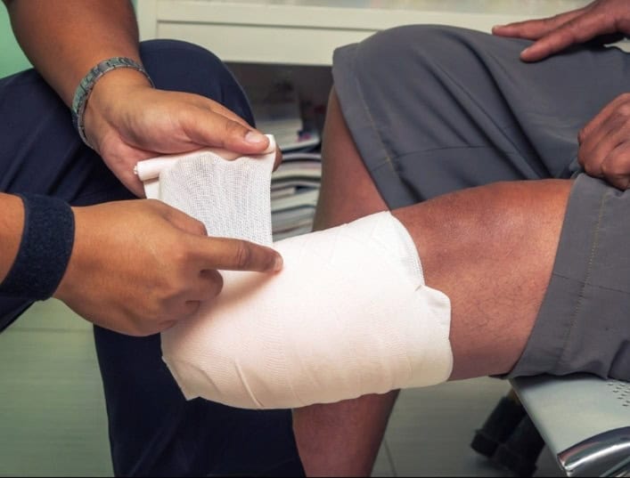 Amputation injury from truck accident with medical bandage applied to leg wound.