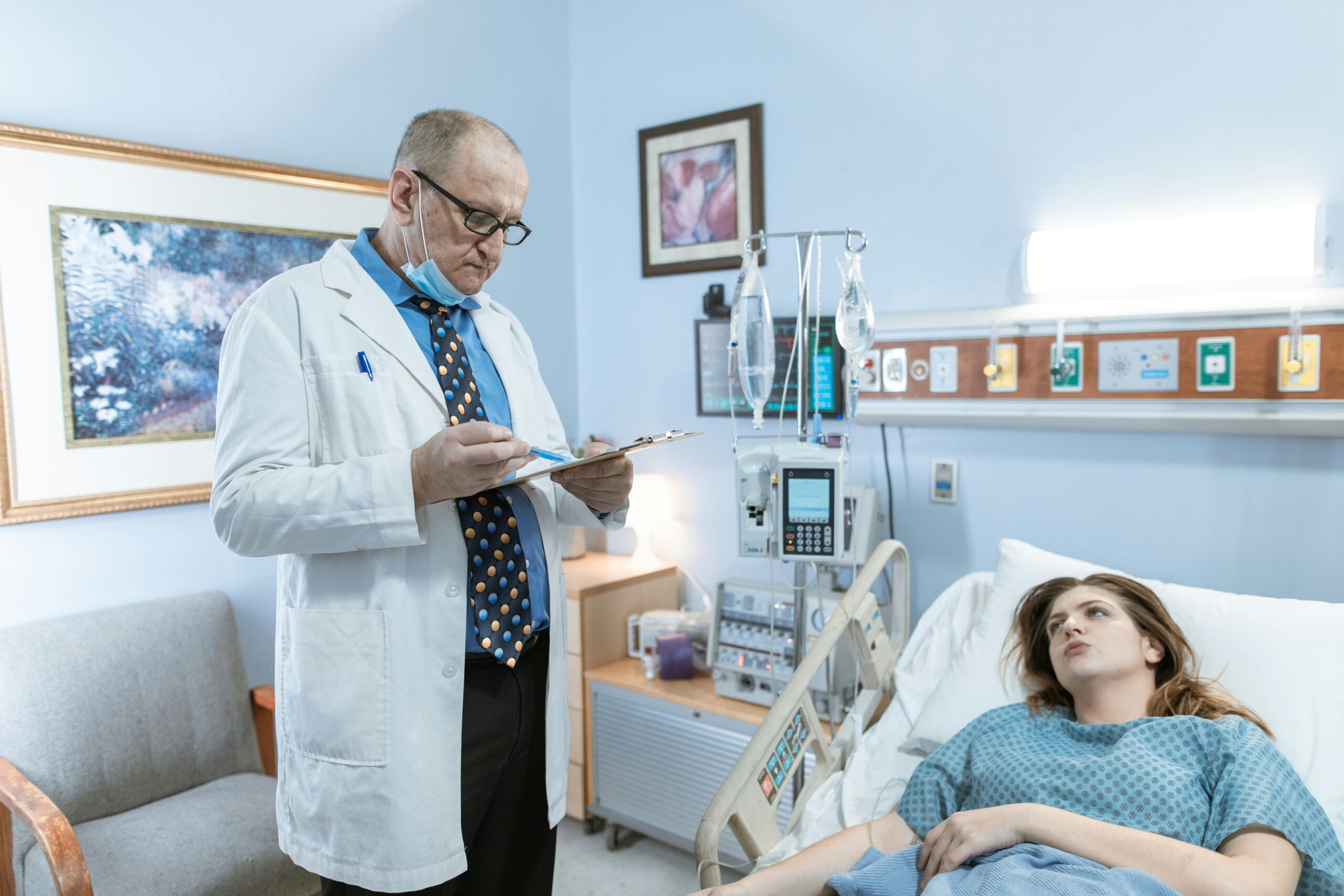 Doctor reviewing patient charts in hospital, highlighting medical malpractice risk.