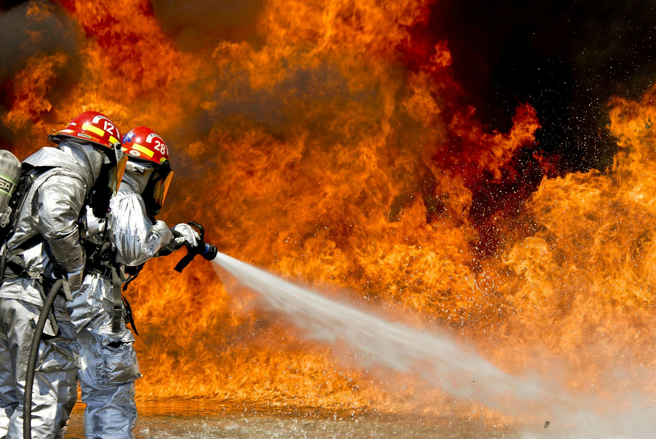 Firefighters battling an intense blaze, highlighting severe burn injury and fire accident risks.