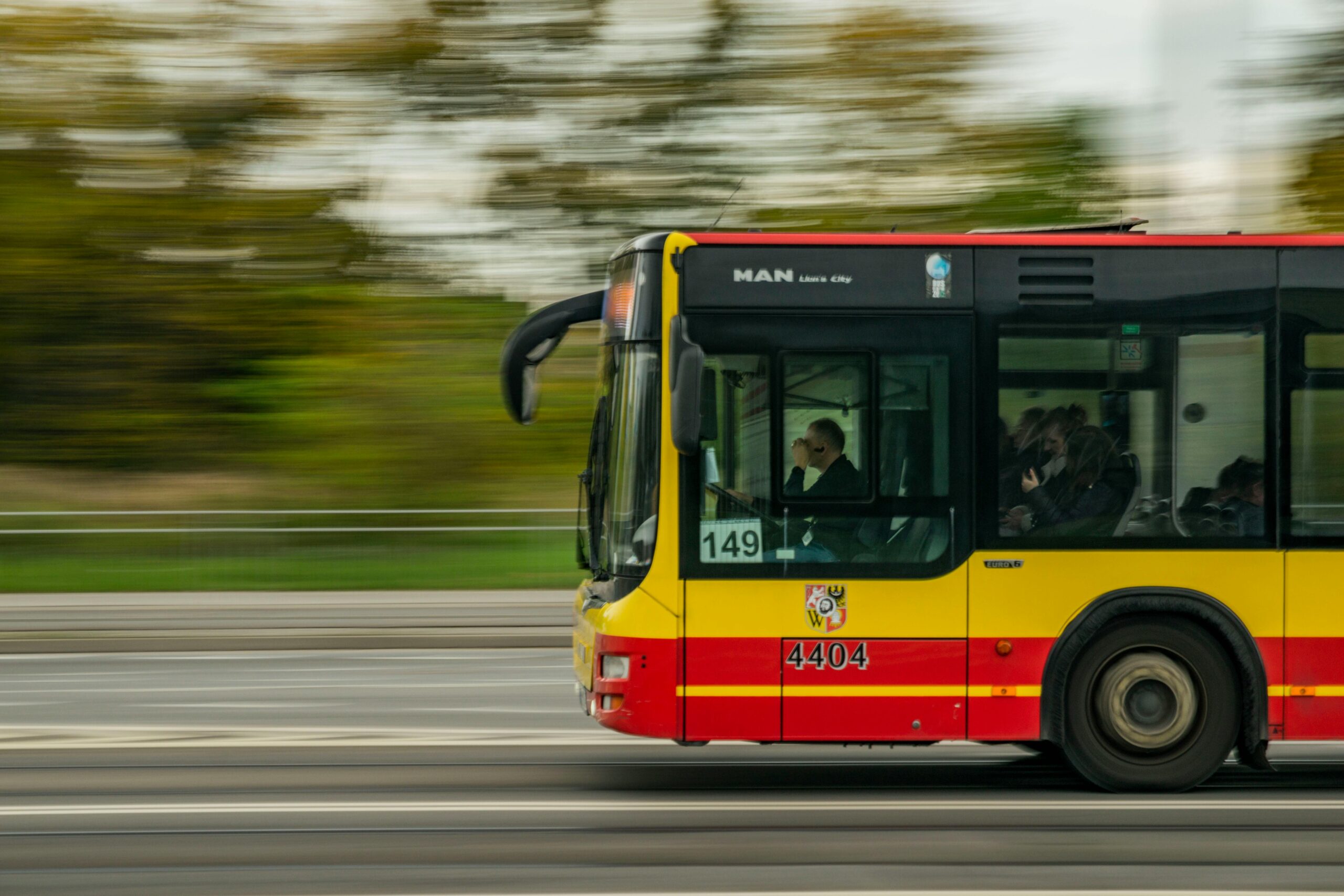 City bus traveling on a busy roadway in New York, representing public transportation and potential bus accident injury risks.