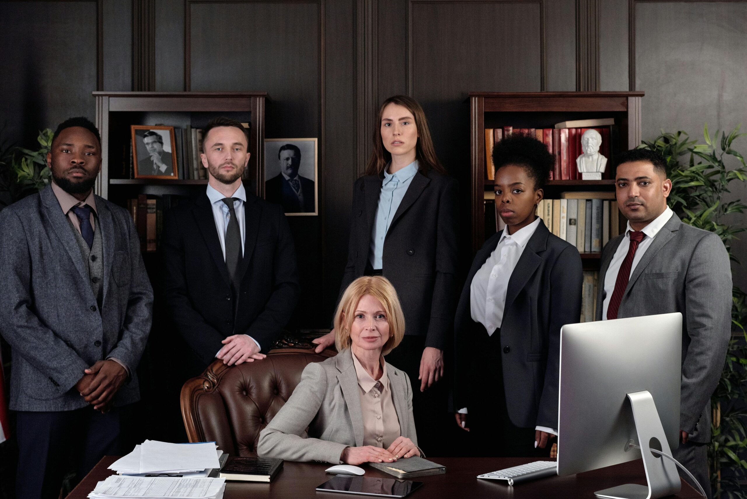 Group of lawyers discussing documents in office for a personal injury claim.