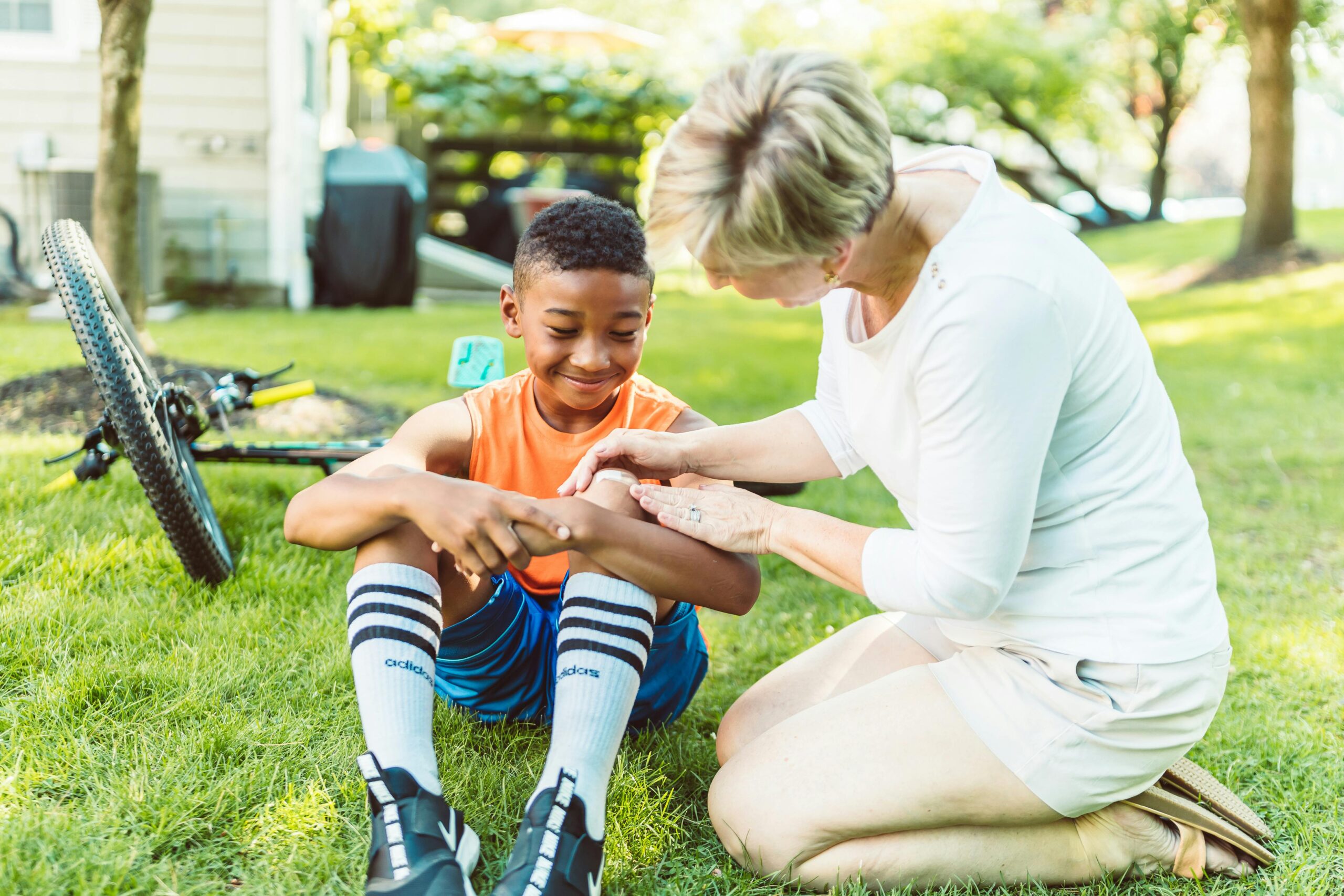 New York Bicycle Accident lawyer assisting injured child after fall from bike outdoors
