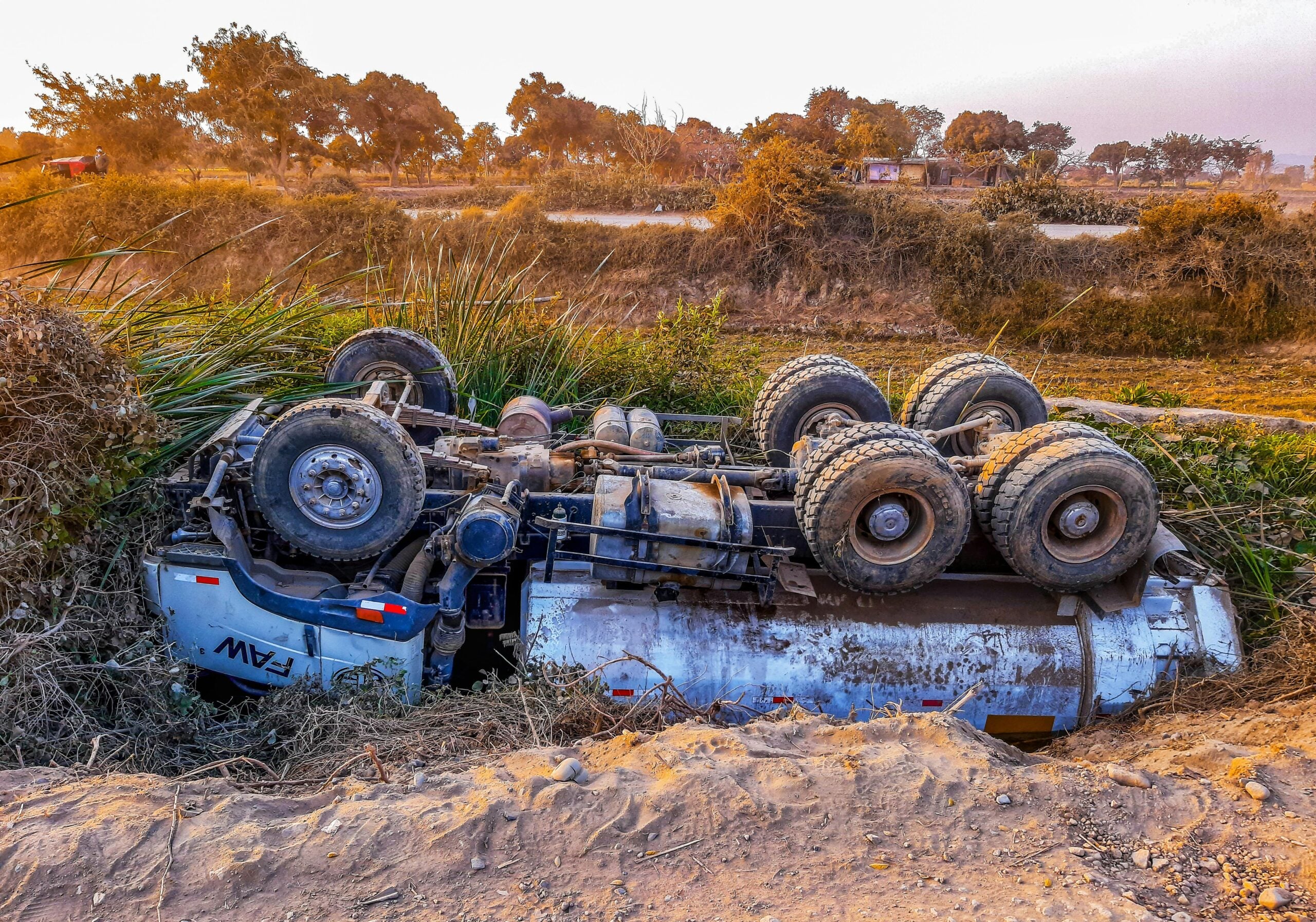 New York truck accident involving overturned trailer in roadside ditch area