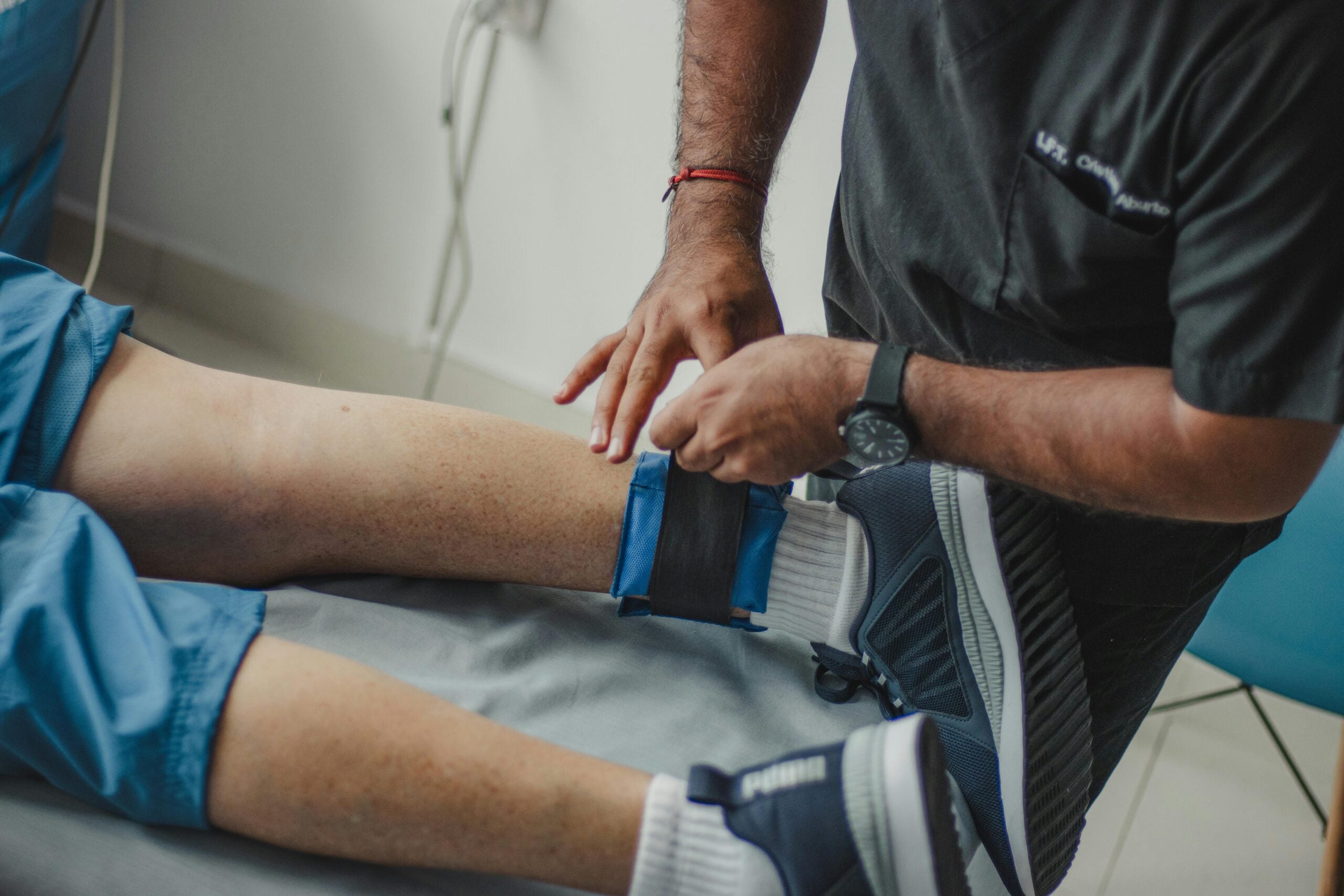 Medical professional assisting injured patient during treatment related to Personal Injury Settlements.