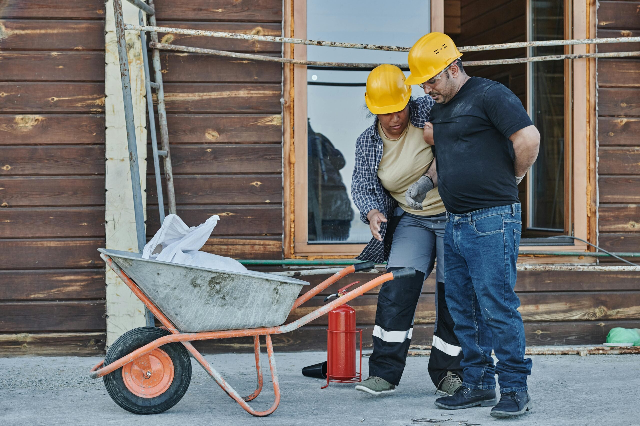 Injured construction worker receiving assistance at Syracuse construction accident site.
