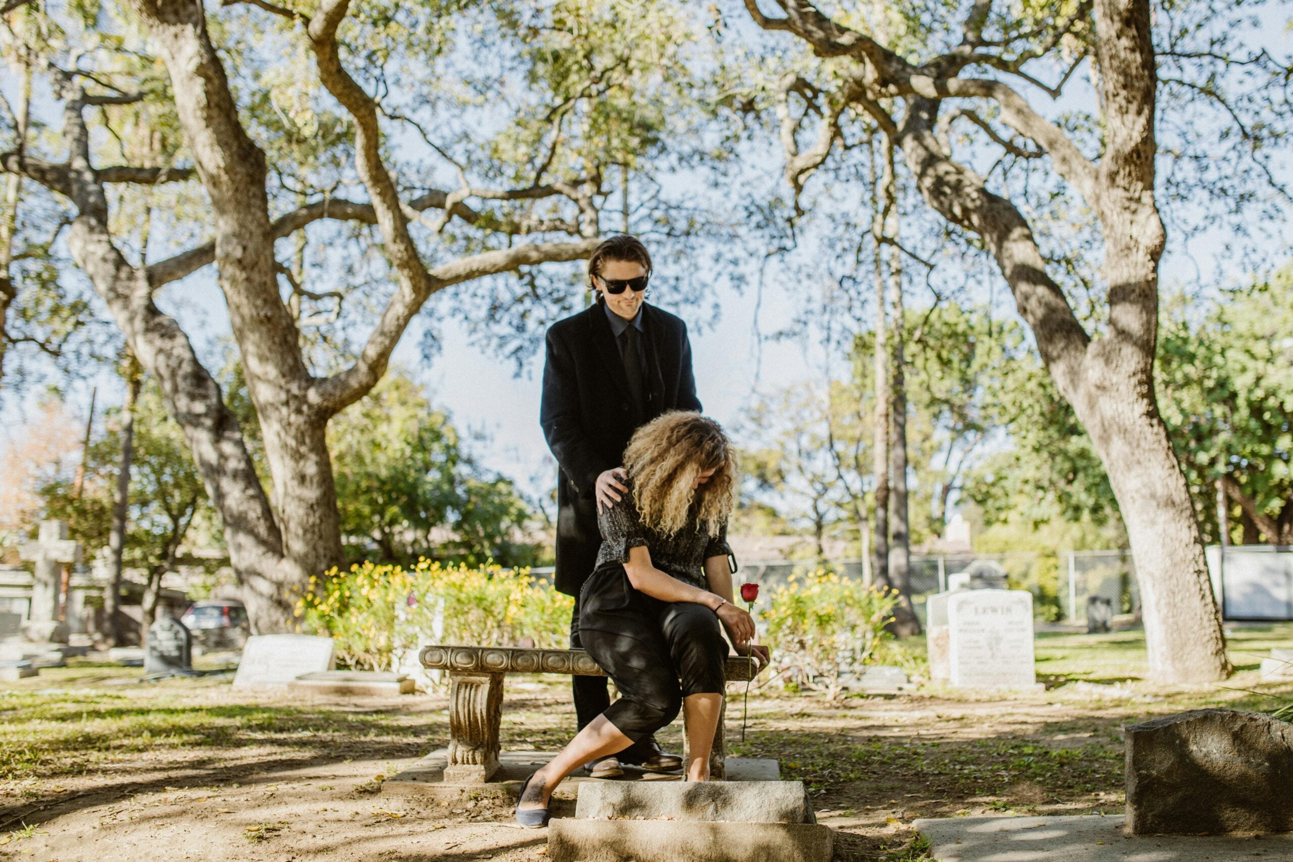 Family grieving at cemetery, representing wrongful death legal cases and damages.