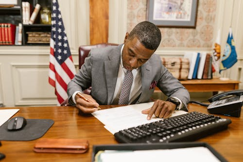 Syracuse Mesothelioma Lawyer signing legal documents in a professional office setting.