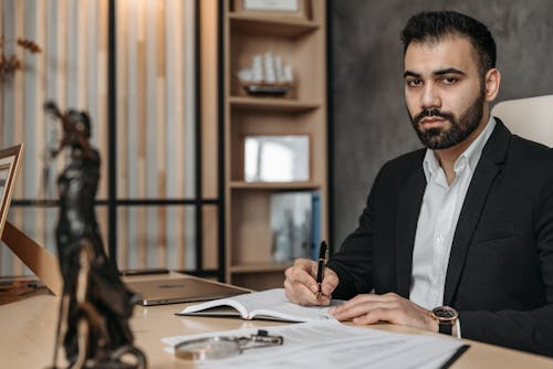 Medical malpractice lawyer reviewing legal documents in an office setting.