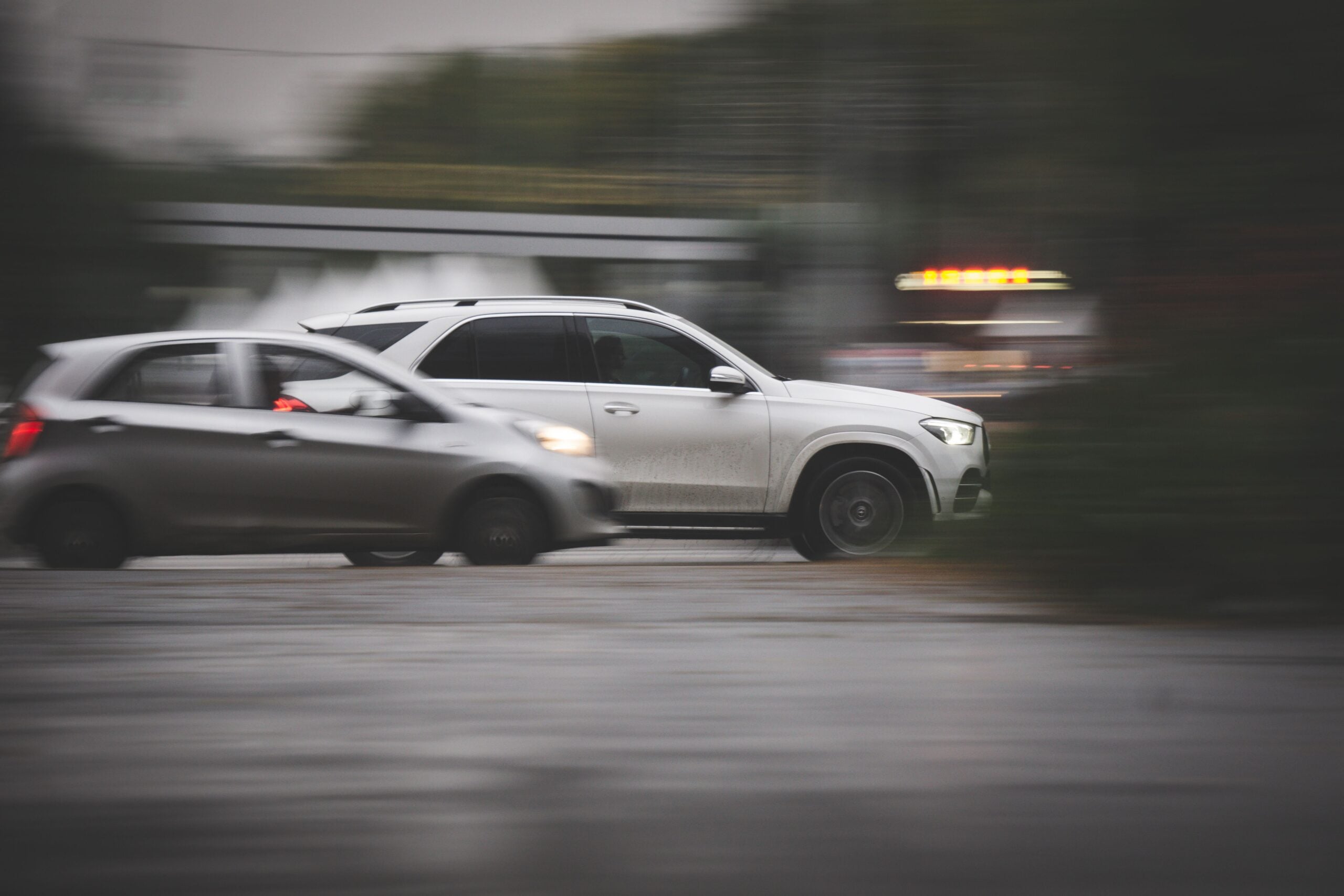 Vehicles traveling through an intersection, illustrating traffic and collision risk.