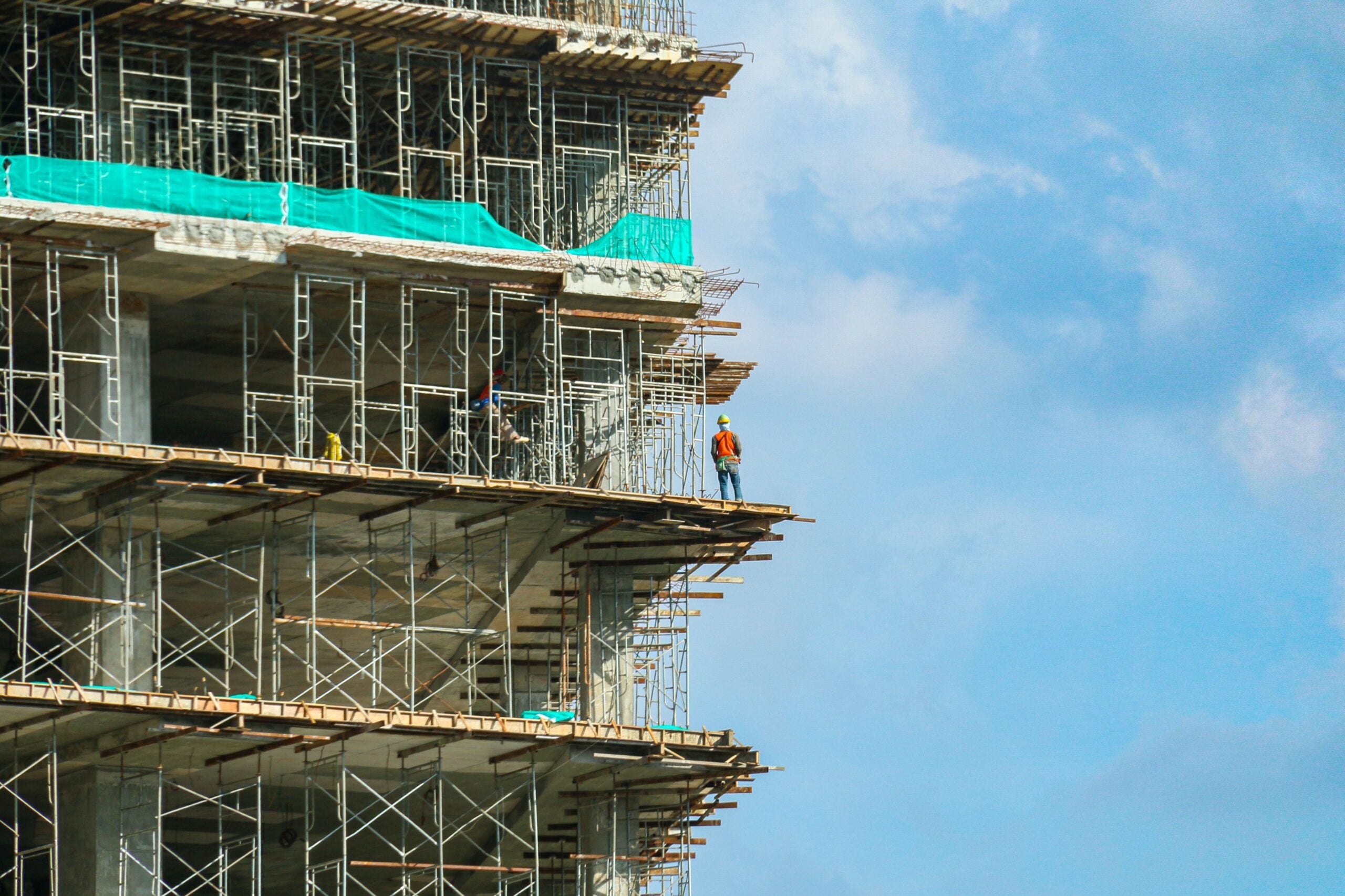 Construction worker on elevated scaffolding, highlighting scaffold accident risks.