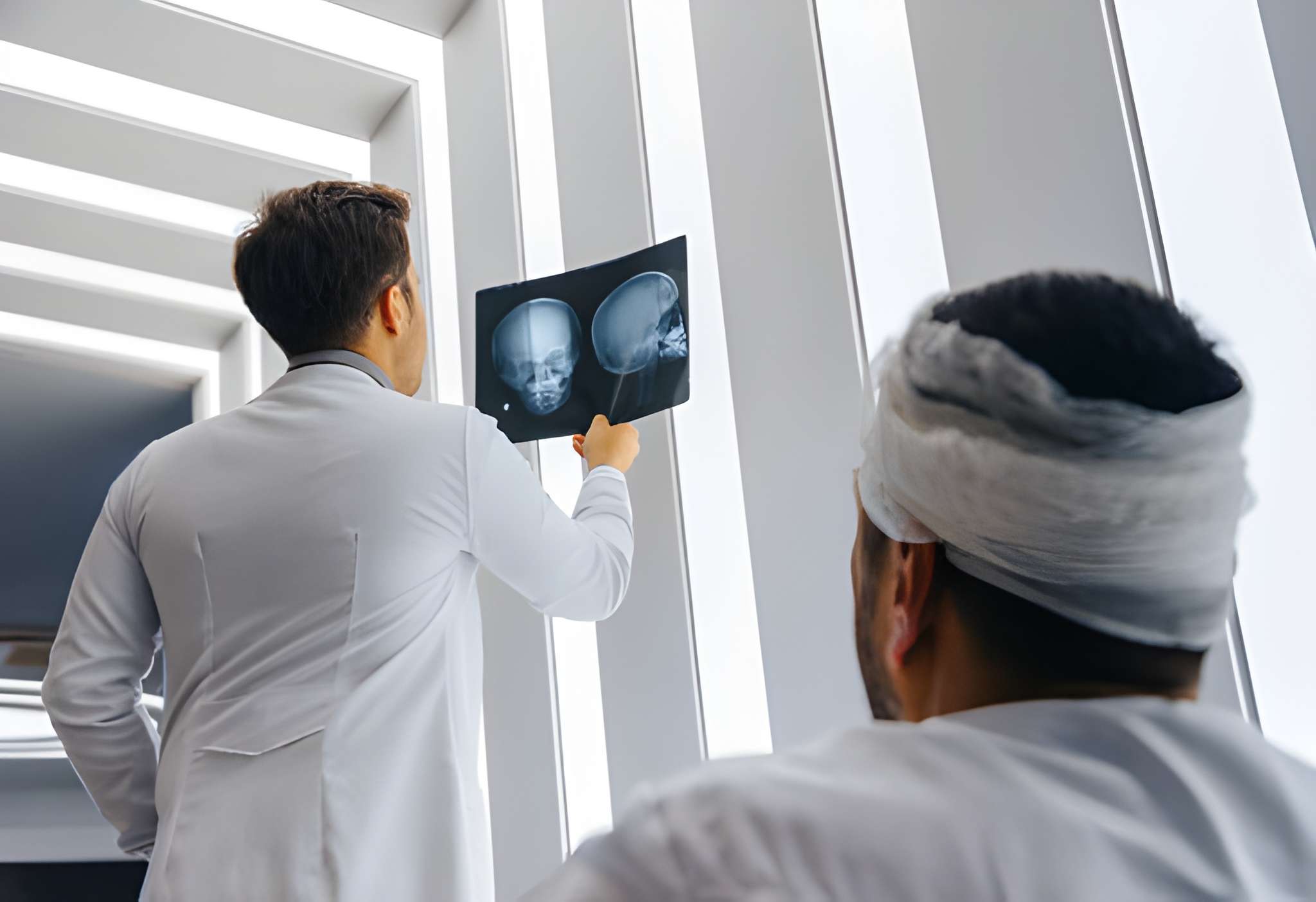 doctor man looking x-ray of the patient's skull